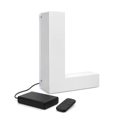 White halo-lit letter L with a black rechargeable battery box and a small remote beside it, on white